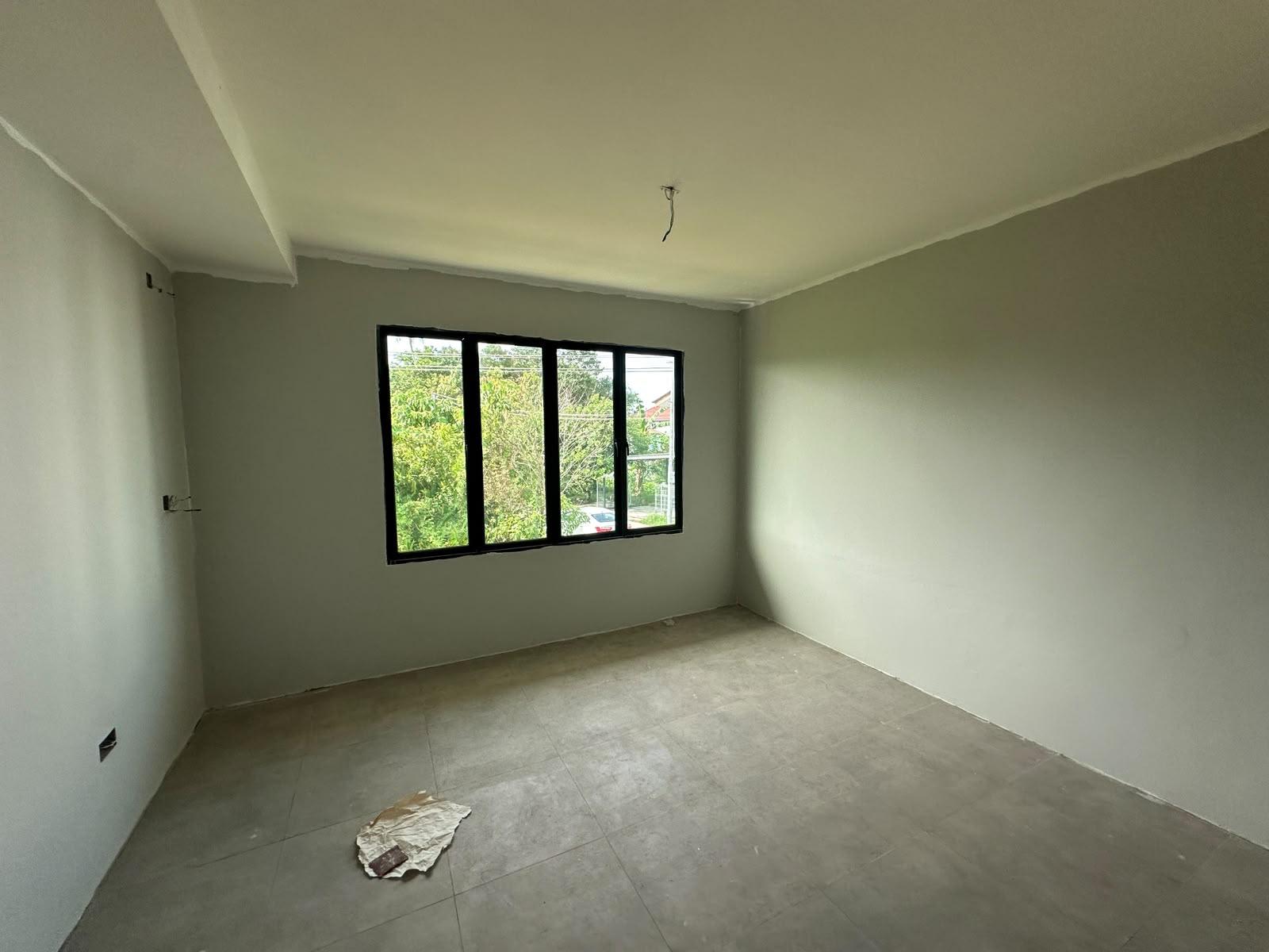 Painted bedroom with a four-panel black window and new floor tiles