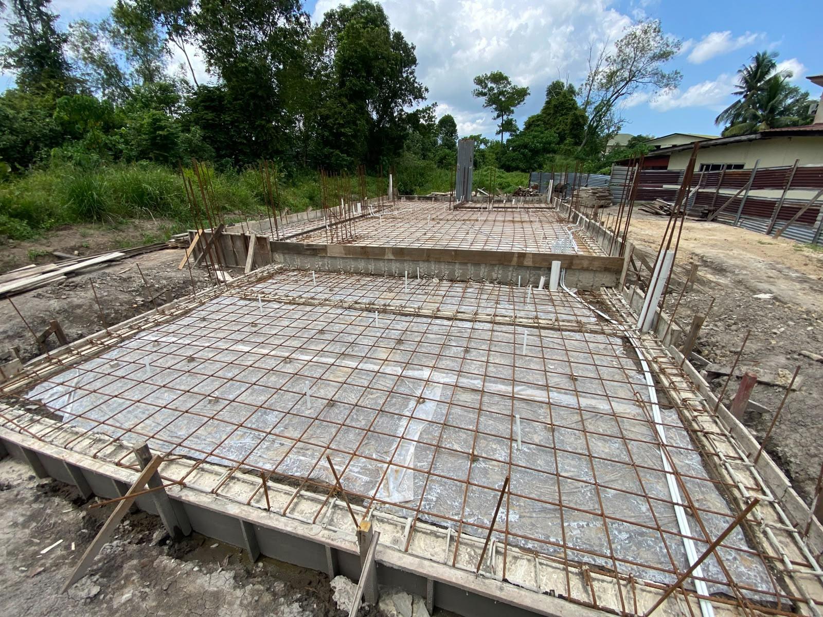 Reinforcing steel and plastic sheeting laid out on the foundation slab